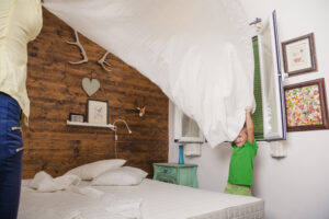 Happy Family Playing With Sheet